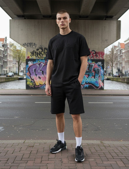 GABBERPLANET black cotton t-shirt with embossed Australian logo on chest, worn by a male model outdoors.