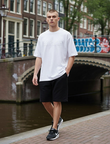 GABBERPLANET white 100% cotton t-shirt with embroidered Australian logo on chest, worn by a male model outdoors.