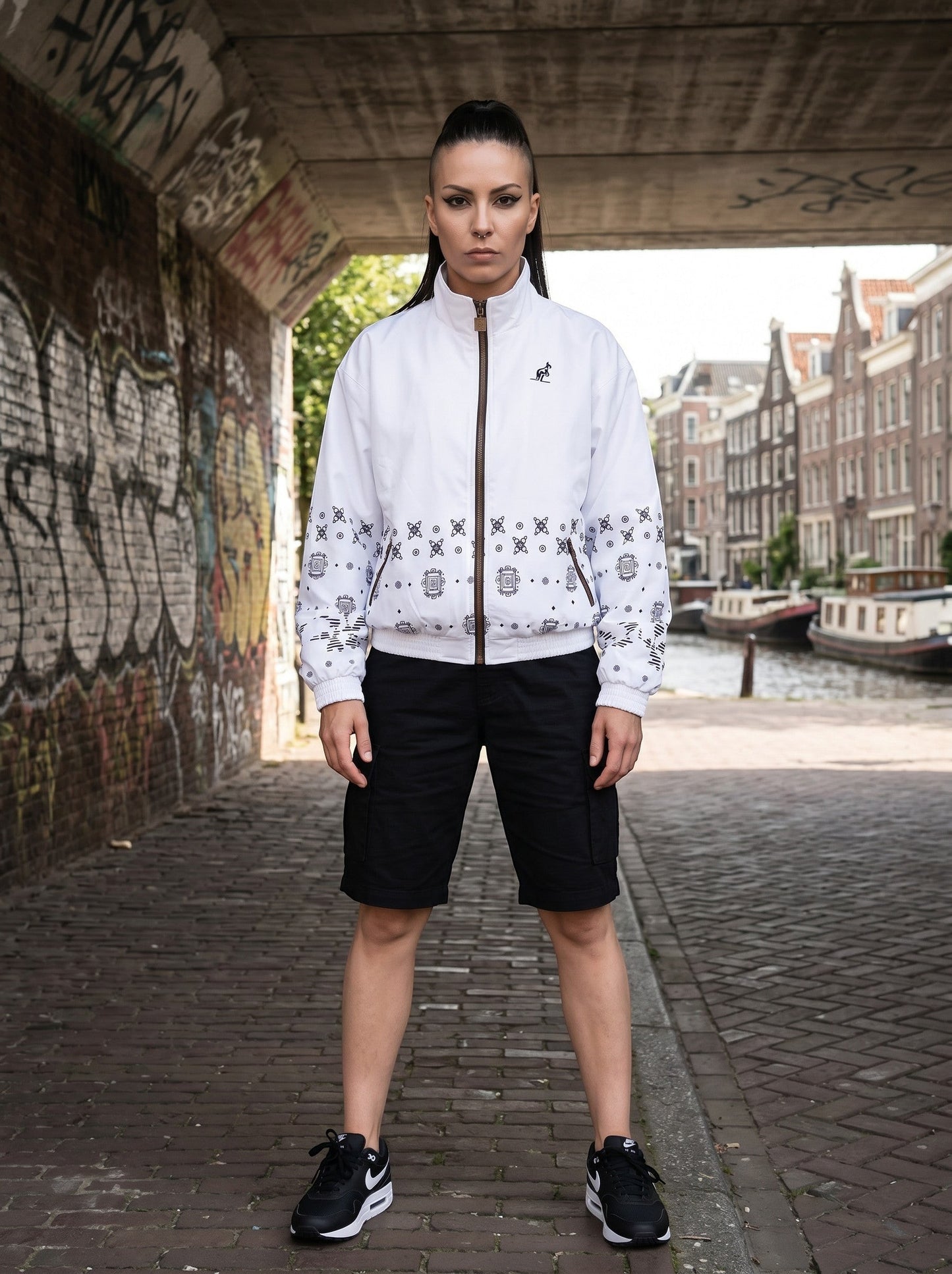 GABBERPLANET white polyester jacket with black graphic print and kangaroo logo, worn by a woman with a high ponytail.